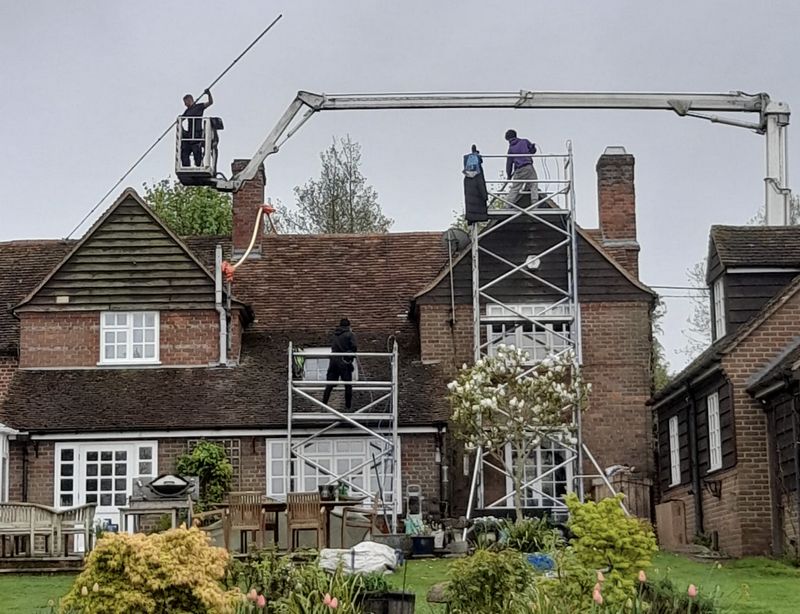 The Moss Cleaners using cherry picker and scaffolding to clean roof safely and professionally in Westbury, Wiltshire